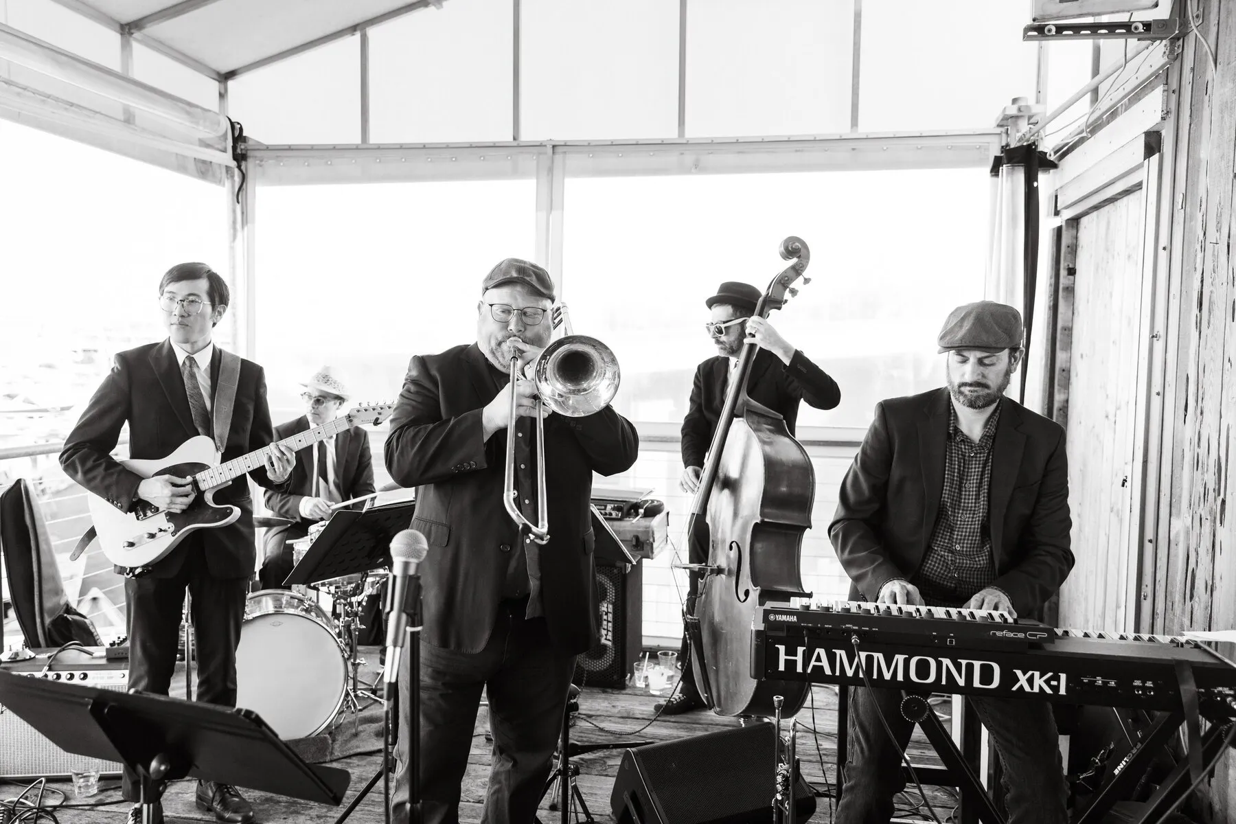 Franco Nero playing live in black and white, two guitars, trombone, upright bass, drums and a Hammond organ