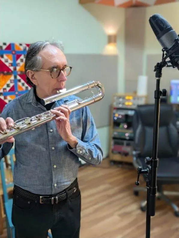 Flutist playing a bass flute into a large-diaphragm mic